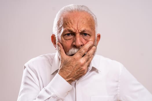 Portrait of surprised and shocked senior man.