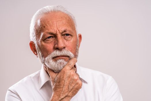 Portrait of pensive and serious senior man.