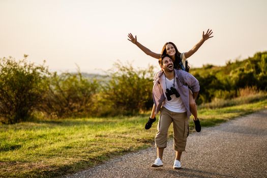 Happy couple is hiking in mountain. They are having fun in nature.