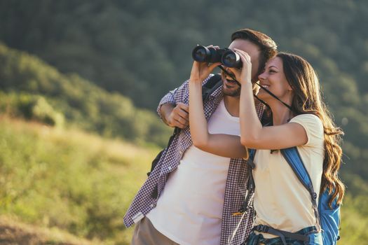 Happy couple is hiking in mountain.