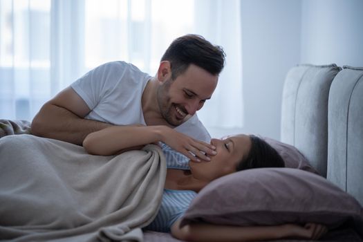 Young couple is lying in bed and waking up in the morning.