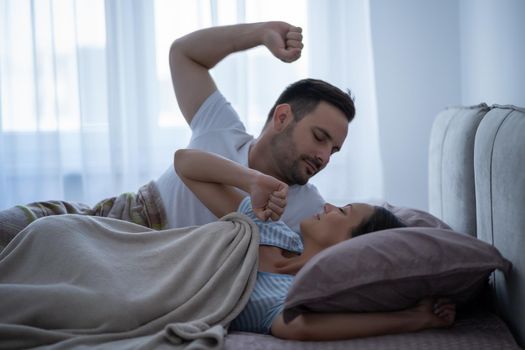 Young couple is lying in bed and waking up in the morning.