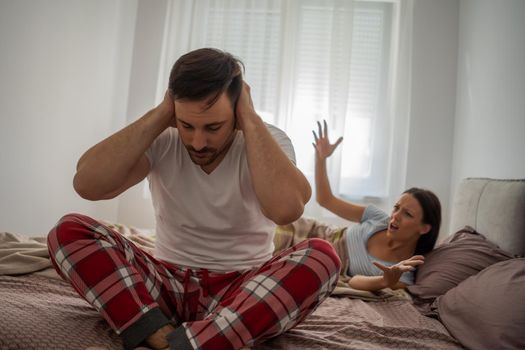 Woman is angry because her man is waking her up.