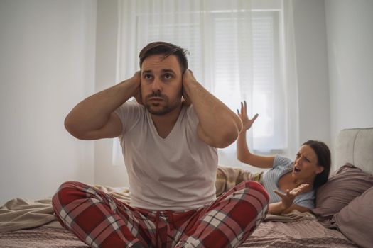 Woman is angry because her man is waking her up.