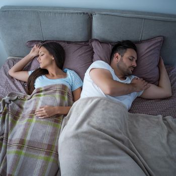 Young couple is sleeping in their bed.