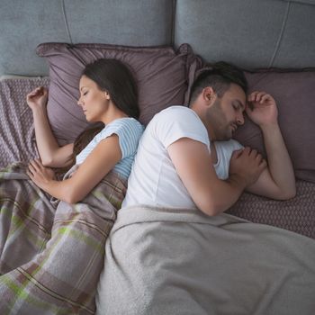 Young couple is sleeping in their bed.