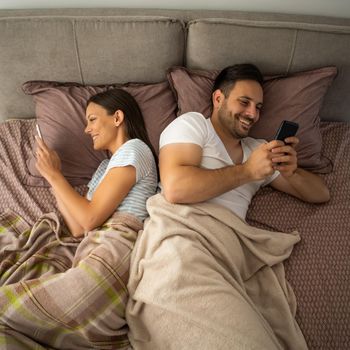 Young couple is resting in bed after work.