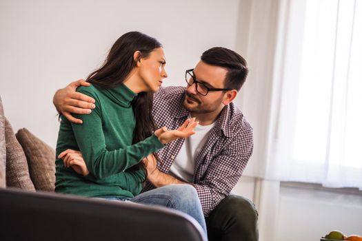 Woman is sad, her man is consoling her.