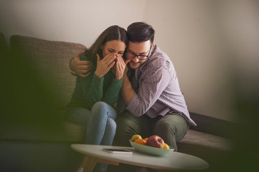 Woman is sad and depressed, her man is consoling her.