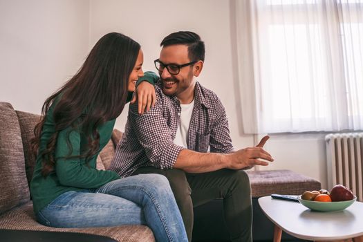 Happy couple is relaxing at home.