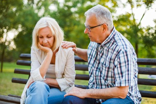 Senior woman is sad and depressed. Friend is consoling her.