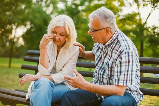 Senior woman is sad and depressed. Friend is consoling her.