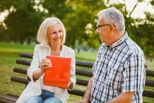 Senior woman is delighted with gift from her man.