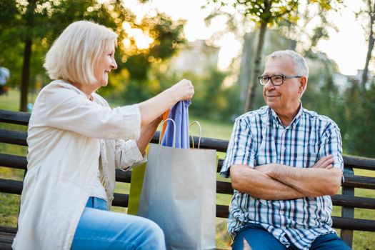 Senior man is angry because his woman is spending money on clothes.