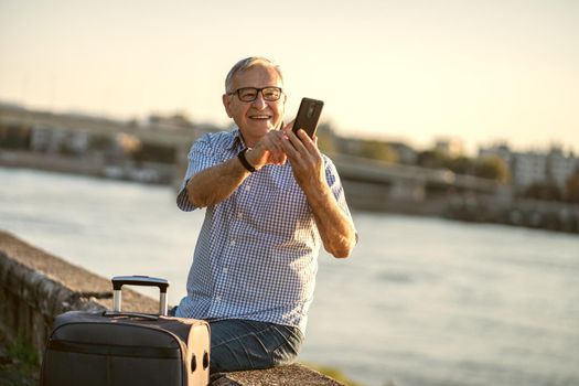 Outdoor portrait of senior man who is traveling.