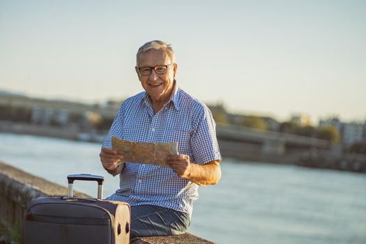 Outdoor portrait of senior man who is on city tour.