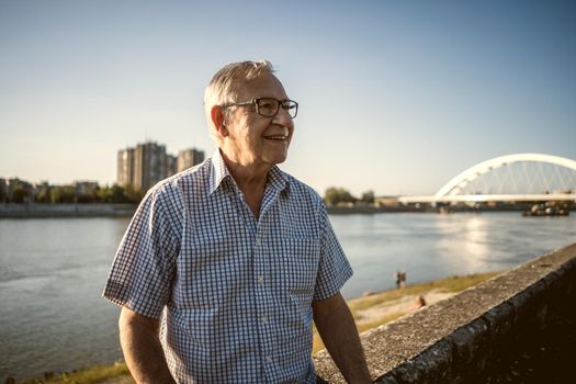 Outdoor portrait of happy senior man who is smiling.