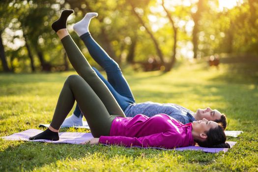Couple is exercising in park. Exercise for sciatica recovery.