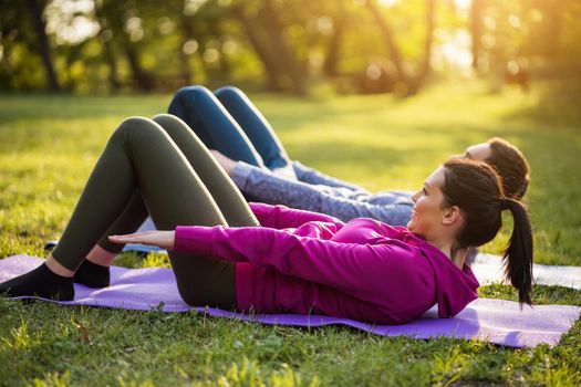 Couple is exercising in park. Exercise for sciatica recovery.