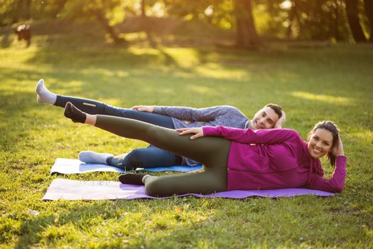 Couple is exercising in park. Exercise for sciatica recovery.