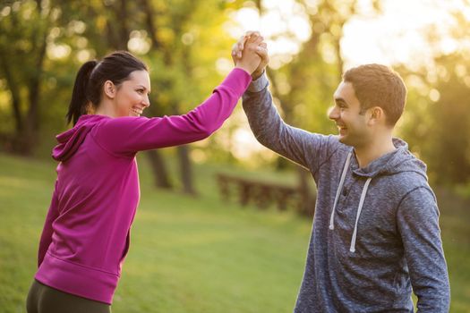 Young couple is happy after exercising in park.