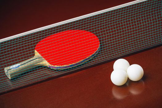 table tennis racket and balls, net background