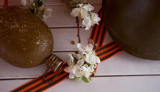 Soldier's flask with St. George ribbons. Victory Day Photos. High quality photo