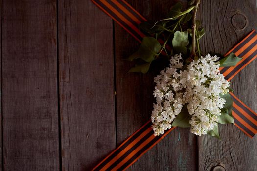 St. George ribbons in the form of a triangle with cherry blossoms. High quality photo