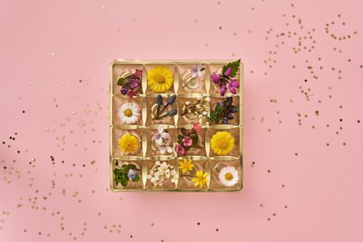 Empty box of chocolates filled with various wild flowers - spring or Mother's Day concept