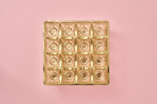 Empty box of chocolates on pink pastel background