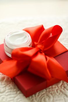 Beauty, cosmetics and skincare styled concept - Luxury face cream jar and red gift box