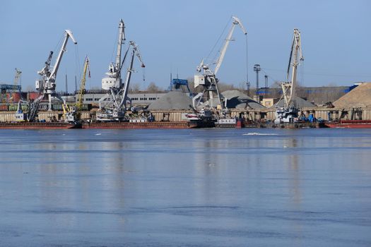 View of a large river and river port with special equipment and water transport. High quality photo