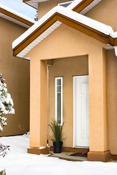 Entrance of residential house with green plant at the door on winter season in Canada
