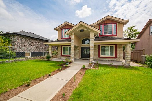 A perfect neighbourhood. Luxury family house with nicely landscaped front yard and concrete stairway to the entrance