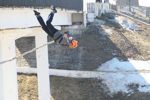 Russia, Nizhny Novgorod, Fedorovsky embankment 04.10.2021.Jump from a bridge with rope, roipjamping. High quality photo