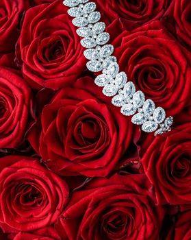 Gemstone jewellery, wedding fashion and luxe shopping concept - Luxury diamond bracelet and bouquet of red roses, jewelry love gift on Valentines Day and romantic holidays present