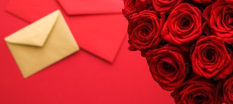 Holiday gift, flowers flatlay and happy relationship concept - Love letter and flower delivery service on Valentines Day, luxury bouquet of red roses and card envelopes on red background