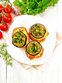 Toasted with egg, tomato, cheese and eggplant slices of bread, sprinkled with dill and parsley in a white plate on napkin on wooden board top background