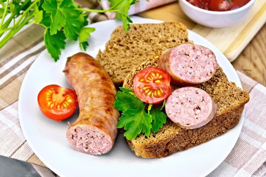 Pork sausages fried in a plate with bread, tomatoes, parsley, tomato sauce, napkin on a wooden boards background