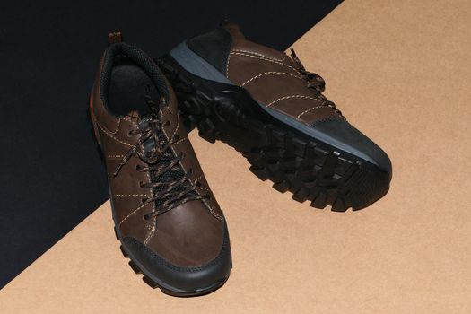 Men's shoes are stylish brown on a black-grey background. High quality photo