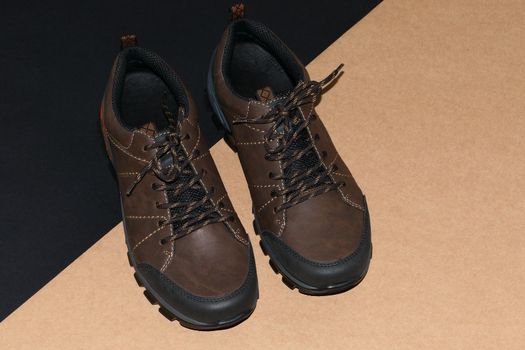 Men's shoes are stylish brown on a black-grey background. High quality photo