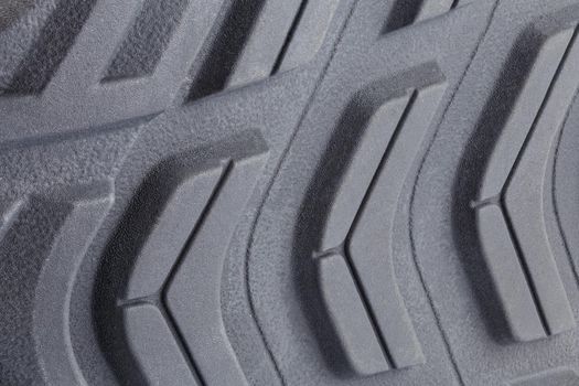 close-up full frame background of new generic contemporary sneakers outsole with protector shapes.