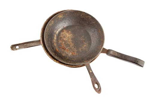 old disgusting stained rusty cast iron pan stack with burnt fat and food leftovers isolated on white background