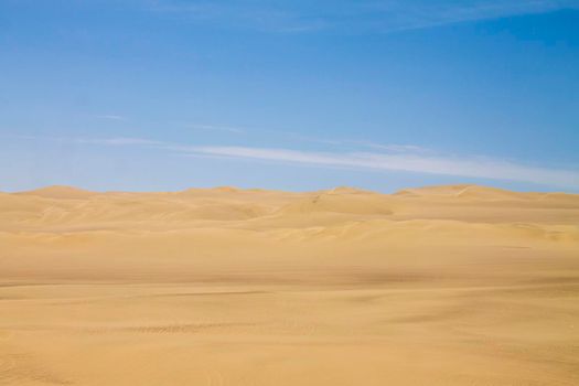 View of the dunes of Ica under the blue sky of Peru