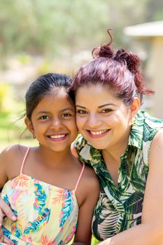 Love between a young mother and her pretty daughter outdoors