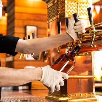 Man pouring, filling beer glass, mug