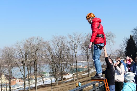 Russia, Nizhny Novgorod, Fedorovsky Embankment.04.10.2021. Jump with rope from the bridge, roupjamping, a man jumps from the bridge. High quality photo