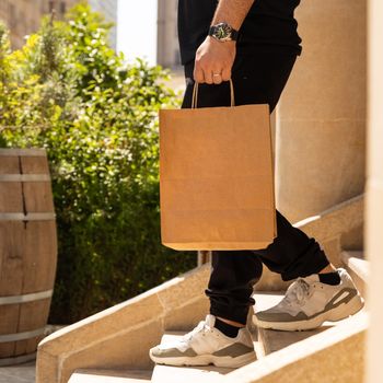 Man going down the stairs with shopping bag