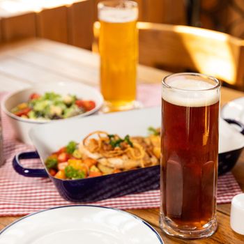 Dark and white beer glasses with dish