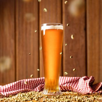 Beer glass with flying malted barley
